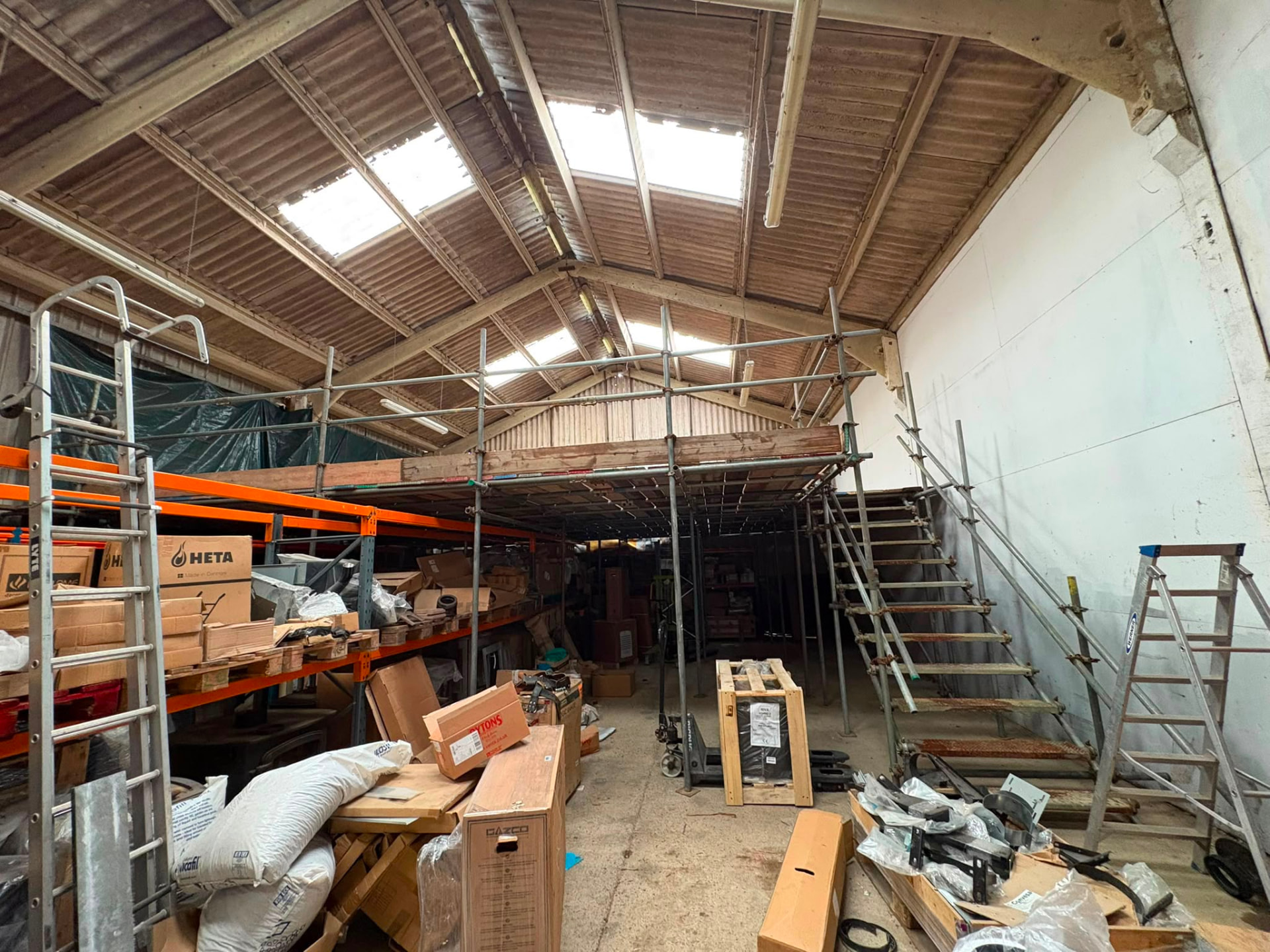 Internal commercial scaffolding platform inside a working warehouse in Kent