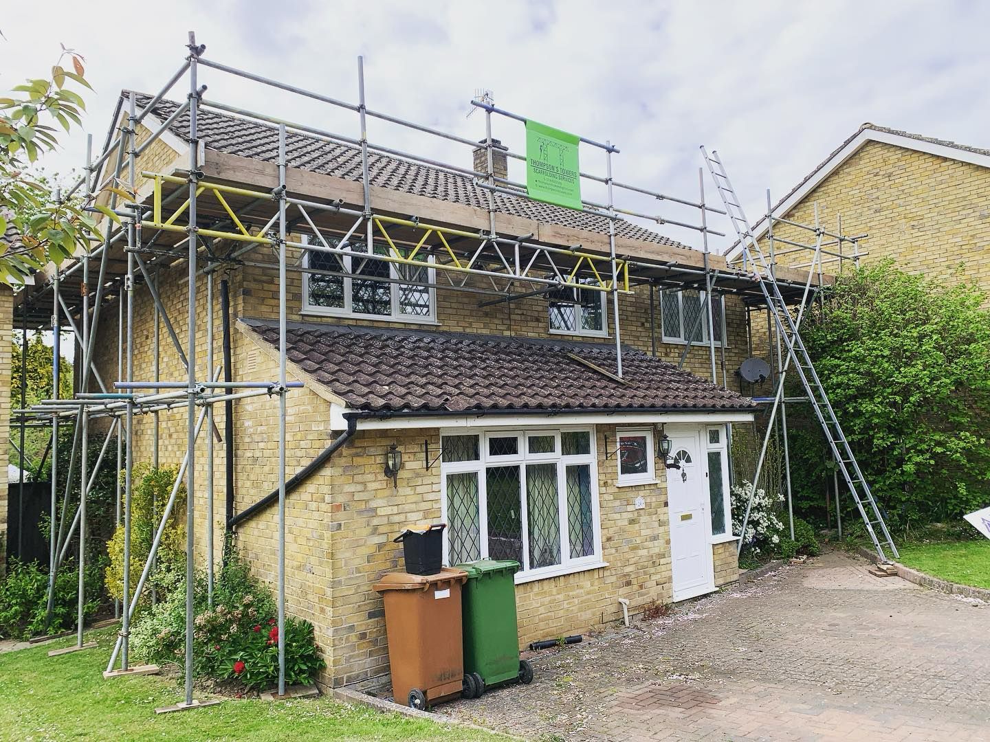 Domestic scaffolding giving roof access on a yellow brick detached house in Kent